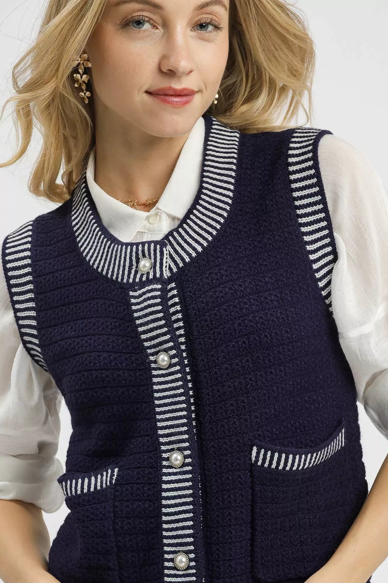 Close-up of Mirren Sweater Vest buttons and striped neckline detail for a classic finish.