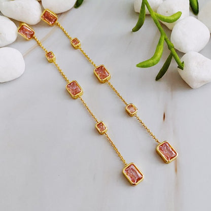 Blush pink Five Stones Dangle Drop Earrings flat lay on marble background