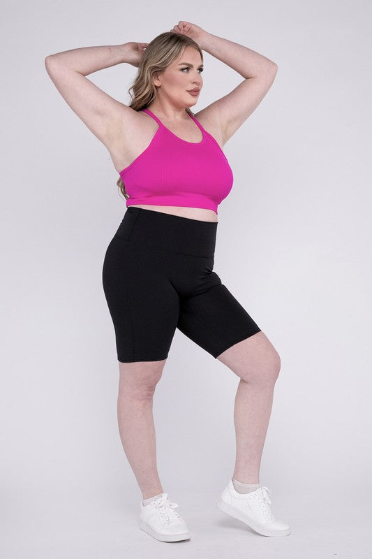 High-rise plus-size athletic biker shorts in black, featuring a fitted silhouette and seamless design for comfort and flexibility.