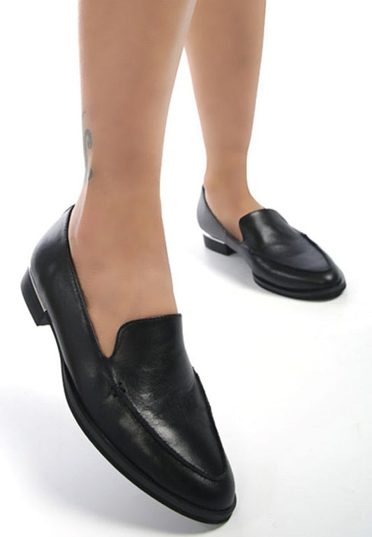 Black leather slip-on loafers made from soft genuine leather with metallic arc detail on the heel, flat heel, breathable insole, and pointed curved toe.