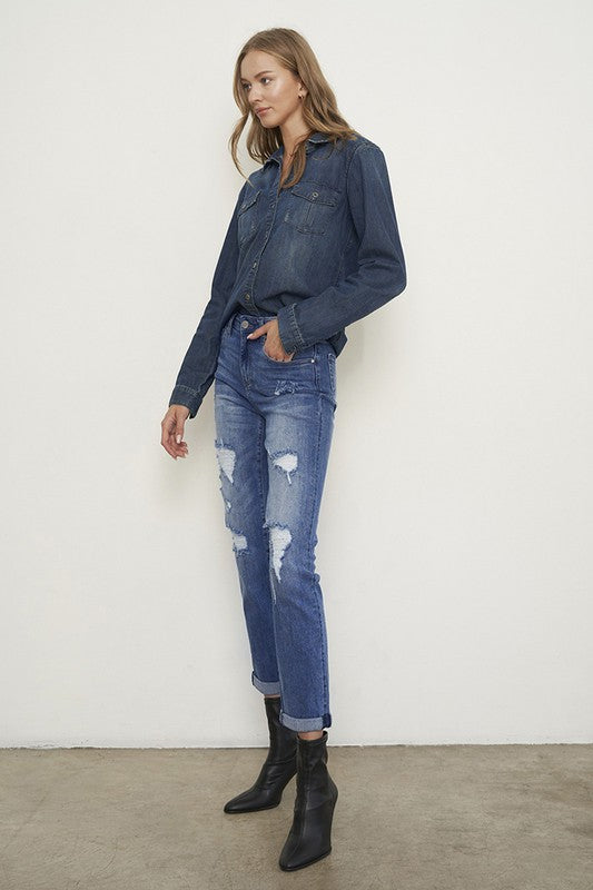 Medium wash distressed girlfriend jeans with a slim fit, mid-rise waist, button closure, and ankle-length cut.