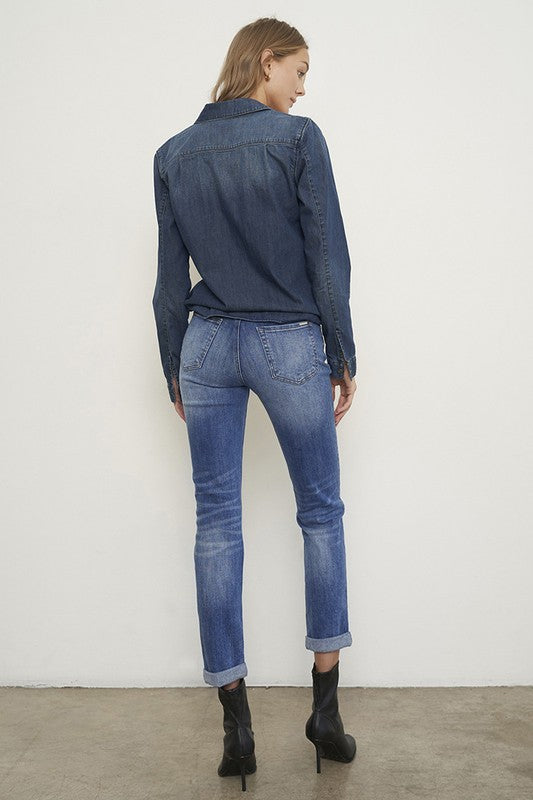 Medium wash distressed girlfriend jeans with a slim fit, mid-rise waist, button closure, and ankle-length cut.