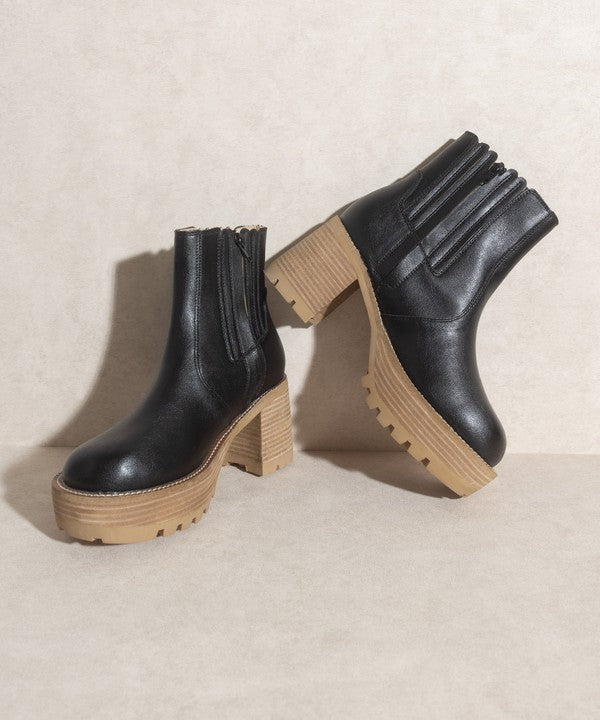 Black pull-on boots with a rounded toe, chunky platform, and high-quality elastic gussets.