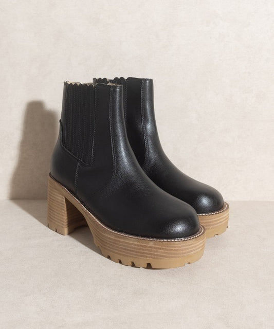 Black pull-on boots with a rounded toe, chunky platform, and high-quality elastic gussets.