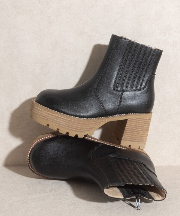 Black pull-on boots with a rounded toe, chunky platform, and high-quality elastic gussets.