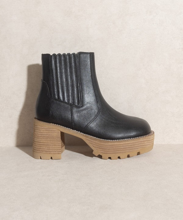 Black pull-on boots with a rounded toe, chunky platform, and high-quality elastic gussets.