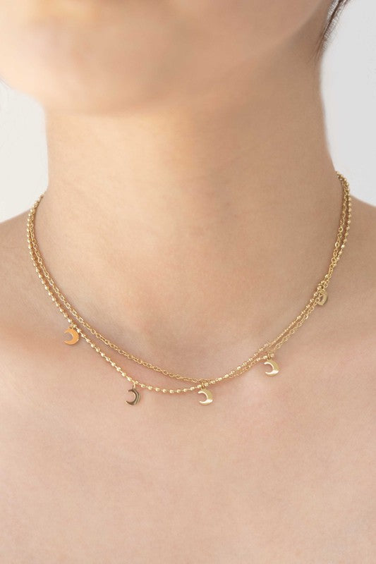 Gold-plated layered necklace with crescent moon charms and an adjustable chain.