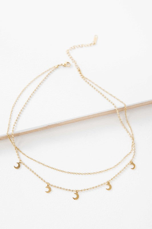 Gold-plated layered necklace with crescent moon charms and an adjustable chain.