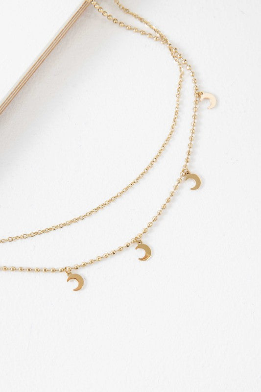 Gold-plated layered necklace with crescent moon charms and an adjustable chain.