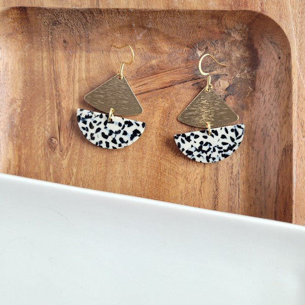 Gold geometric dangle earrings with black dots, featuring leverback closure.