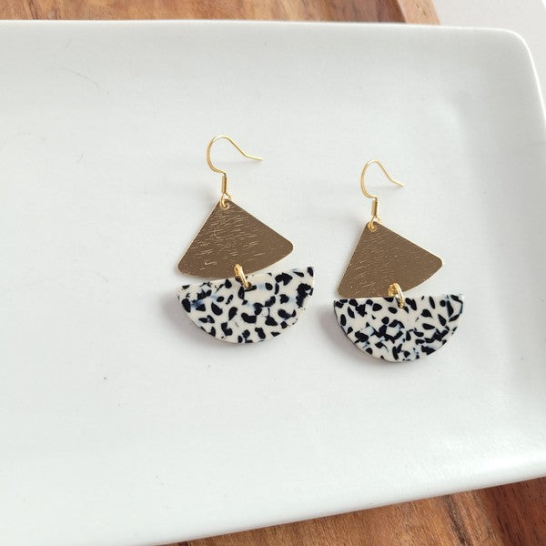 Gold geometric dangle earrings with black dots, featuring leverback closure.