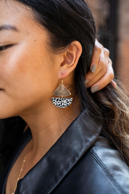 Gold geometric dangle earrings with black dots, featuring leverback closure.