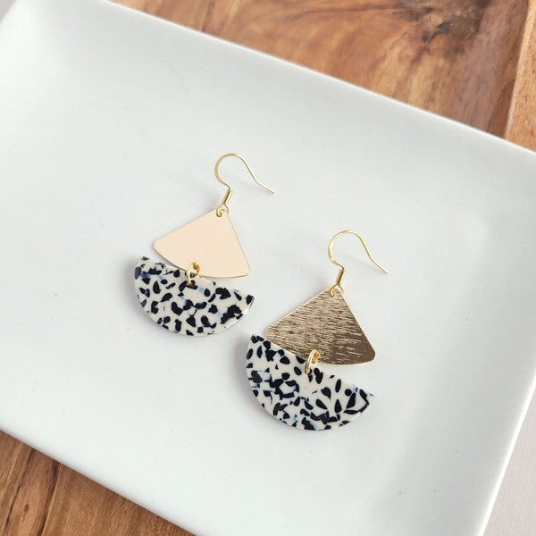 Gold geometric dangle earrings with black dots, featuring leverback closure.