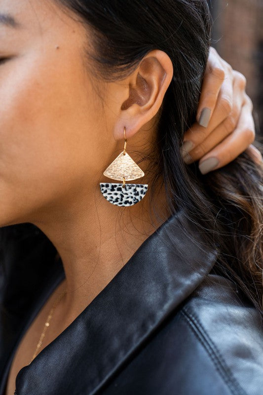 Gold geometric dangle earrings with black dots, featuring leverback closure.