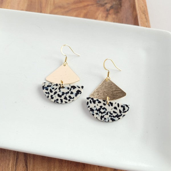 Gold geometric dangle earrings with black dots, featuring leverback closure.