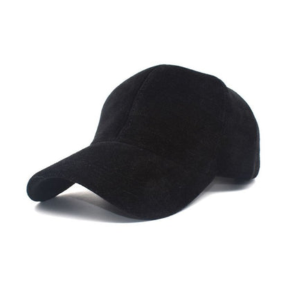 Black velour ball cap close up, velour texture, curved brim, structured design.