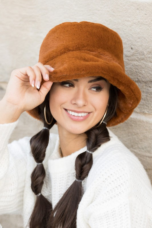 Woman wearing Izzie Plush Bucket Hat in Camel, front view showing fuzzy plush texture and structured brim