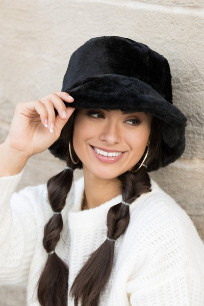 Woman wearing Izzie Plush Bucket Hat in Black, front view with fuzzy plush texture and autumn-ready style