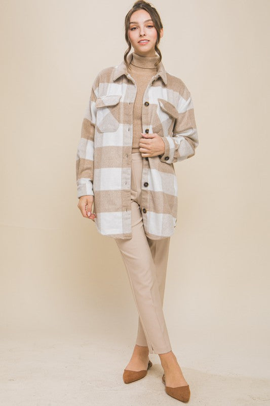 Khaki plaid shacket with button closure, long sleeves, and functional pockets.