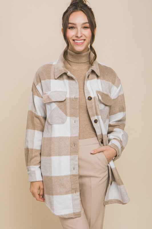 Khaki plaid shacket with button closure, long sleeves, and functional pockets.