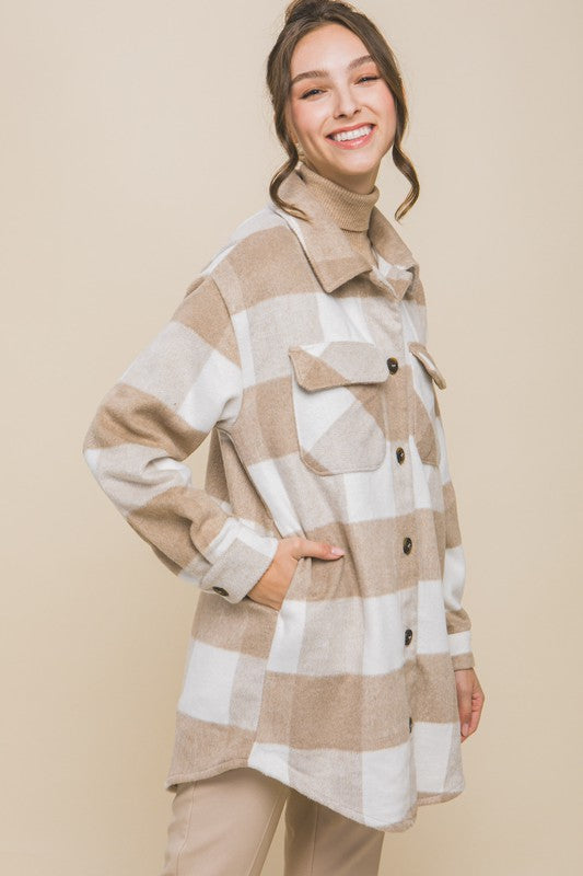 Khaki plaid shacket with button closure, long sleeves, and functional pockets.