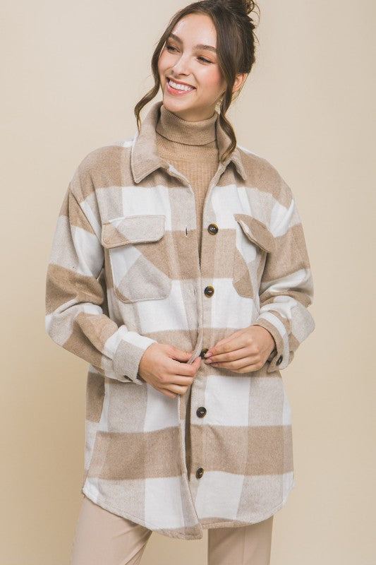 Khaki plaid shacket with button closure, long sleeves, and functional pockets.