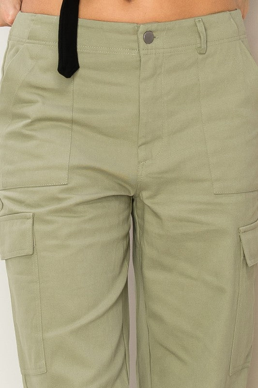 Sage high-waisted cargo pants with a straight-leg fit, functional side pockets, and zip fly.