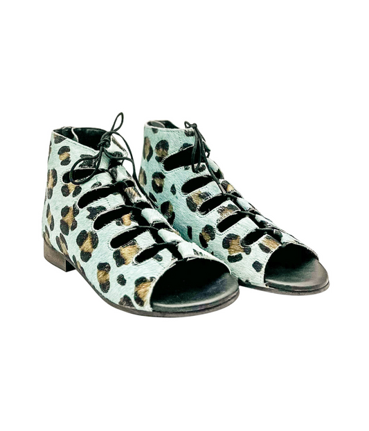 Side angle of Nola Teal Leopard Sandals with lace-up front and flat heel design