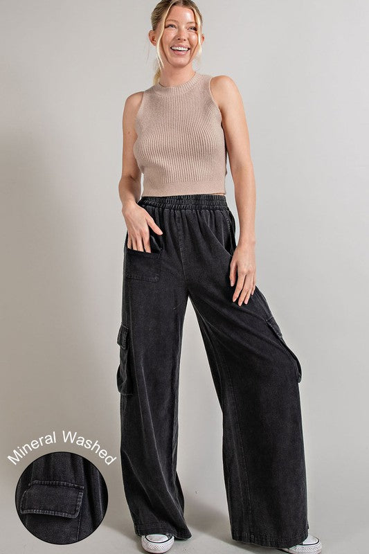 Wide-leg mineral-washed cargo pants in ash gray with an elastic waist and multiple pockets.