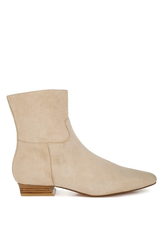 Side outside view of beige Hakra suede ankle boots showing flared heel, paneling detail, and smooth suede finish.