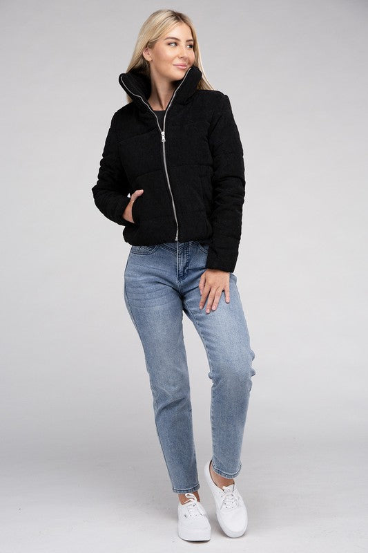 Black corduroy zip-up jacket with a high collar, long sleeves, and a pocket.