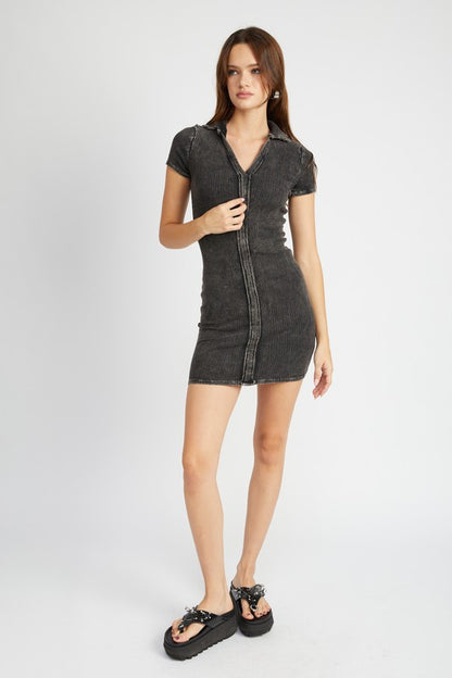 Full body view of model wearing Gretchen Exposed Seam Mini Dress in black, styled with heels for a chic look.