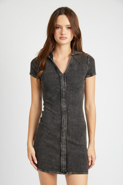 Front view of model wearing the Gretchen Exposed Seam Mini Dress in black, showcasing collared V-neck and fitted silhouette.