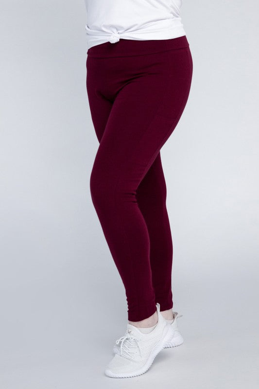 Full-length curvy plus leggings in dark burgandy with a high-rise thick waistband, fitted silhouette, and convenient leg pockets.