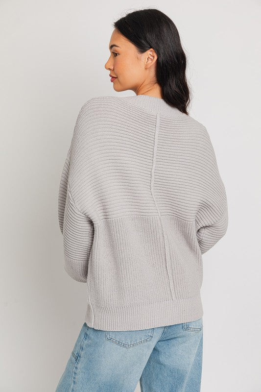 Grey ribbed knit sweater with balloon sleeves and banded cuffs.