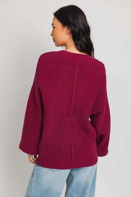 Wine ribbed knit sweater with balloon sleeves and banded cuffs.