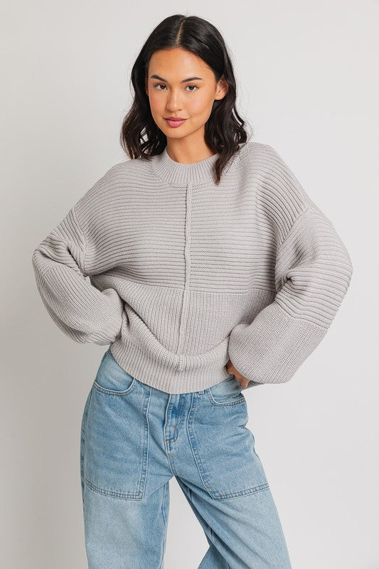 Grey ribbed knit sweater with balloon sleeves and banded cuffs.