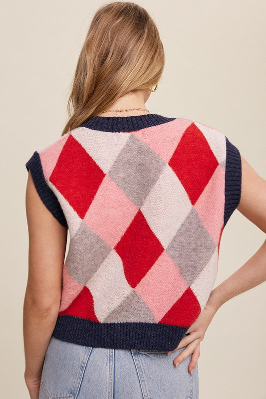 Red, multi-color patterned sweater vest, oversized fit, with a V-neck and sleeveless design.