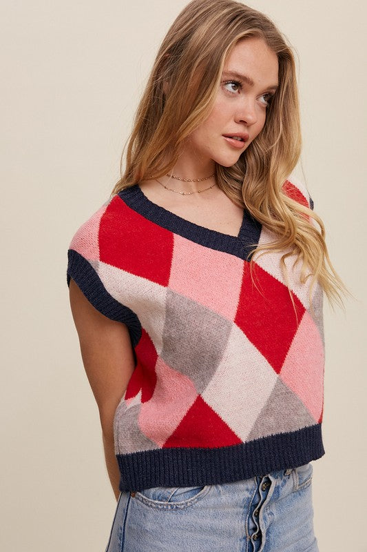 Red, multi-color patterned sweater vest, oversized fit, with a V-neck and sleeveless design.