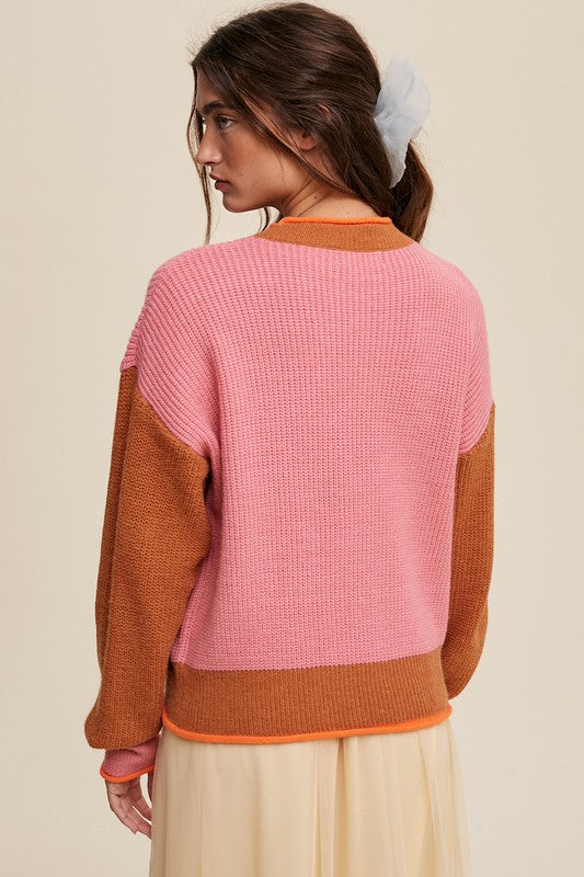 Color block ribbed knit sweater in pink, rust, and orange, featuring a round neckline, drop shoulders, and long sleeves. Regular fit, pullover design.