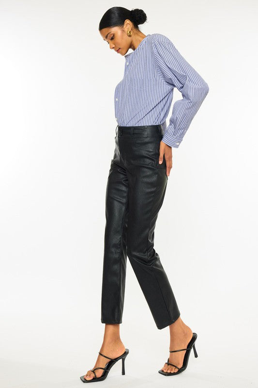 Black faux leather, high rise skinny jeans by Kan Can USA, featuring cropped, straight leg design, and double button closure. 