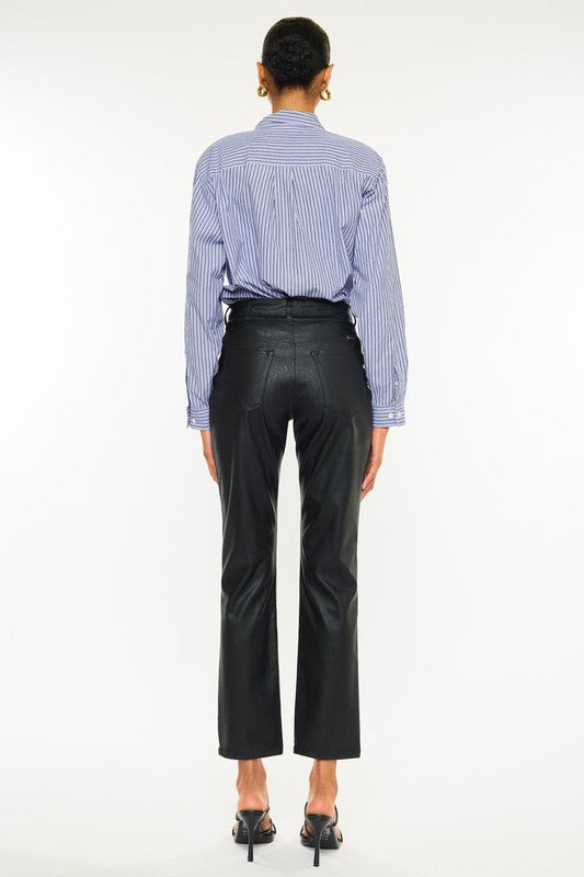 Black faux leather, high rise skinny jeans by Kan Can USA, featuring cropped, straight leg design, and double button closure. 