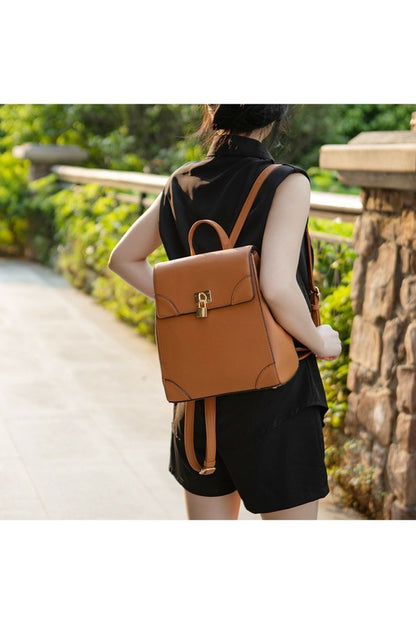 Woman wearing brown Sansa vegan leather backpack over single shoulder.