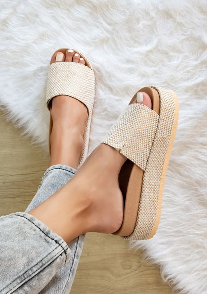 Woman wearing natural beige Tina Woven Flatform Sandals with 2-inch cushioned sole and slip-on woven strap.