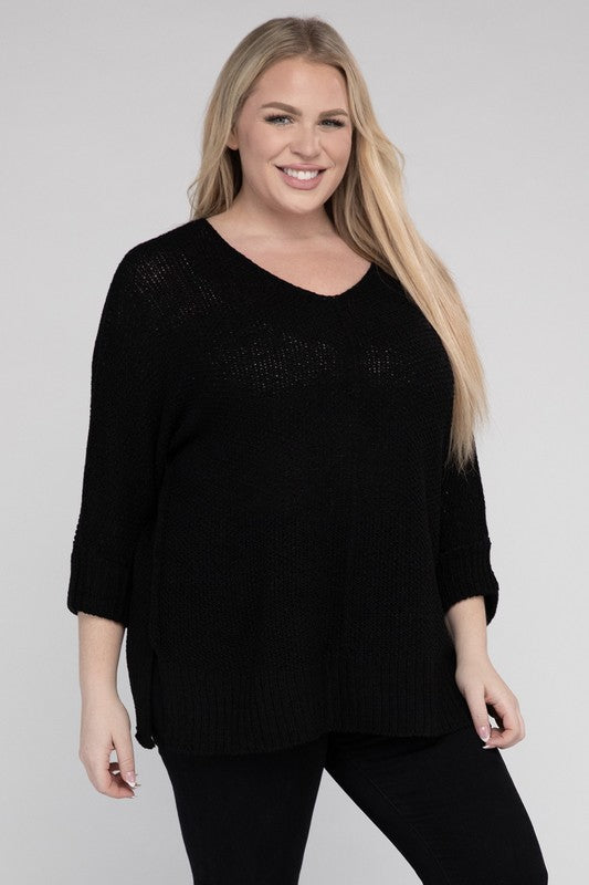 Black plus size crew neck sweater with a loose fit, side slits, long sleeves, and a cozy knit fabric for warmth.