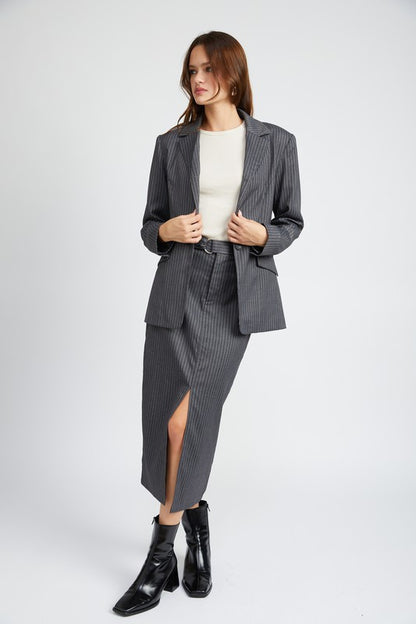 Full body view of Clementine Pinstripe Blazer styled with matching skirt and boots
