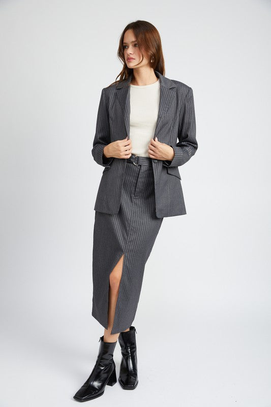 Full body view of Clementine Pinstripe Blazer styled with matching skirt and boots
