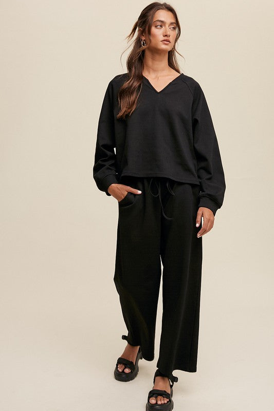 Solid casual sweatshirt and pants set with a V-neck, long sleeves, and drawstring waist.