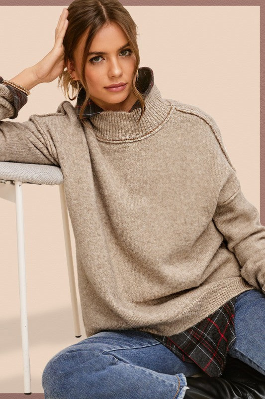 Cozy knit mock neck sweater in taupe, featuring long sleeves, drop shoulders, and an oversized fit.