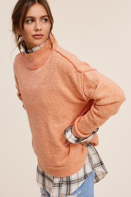 Cozy knit mock neck sweater in pumpkin, featuring long sleeves, drop shoulders, and an oversized fit.